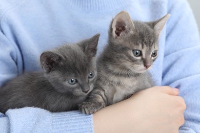Photo of Woman with cute fluffy kittens, closeup view