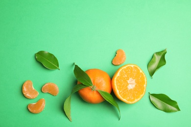 Flat lay composition with ripe tangerines on color background. Space for text