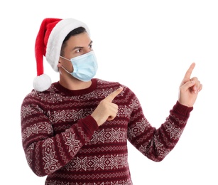 Photo of Man wearing Santa hat and medical mask on white background