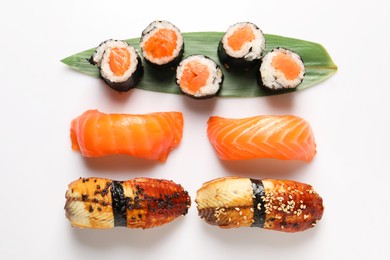 Photo of Different tasty sushi rolls on white background, flat lay