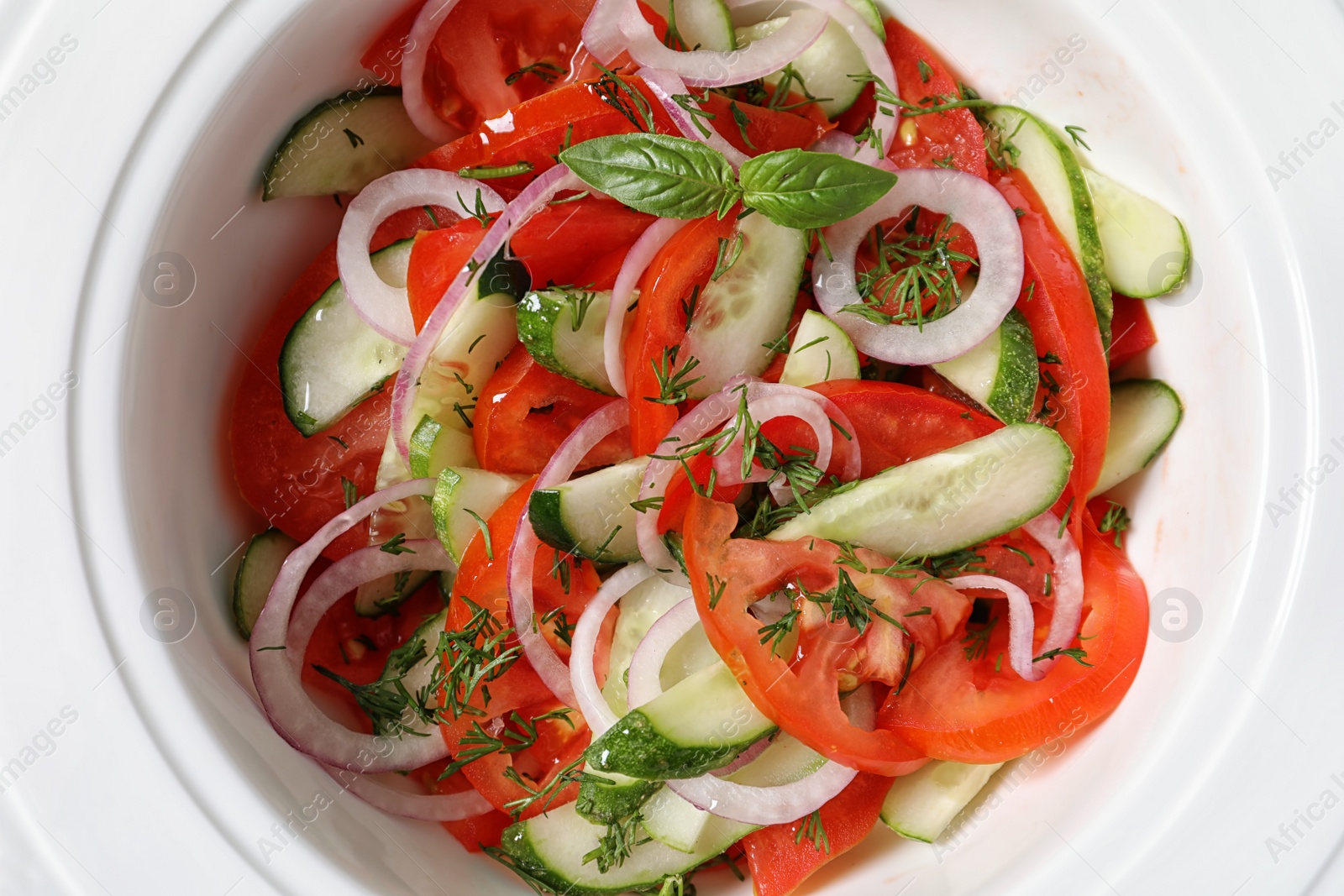 Photo of Plate with delicious fresh salad, top view