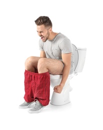 Young man suffering from diarrhea on toilet bowl. Isolated on white