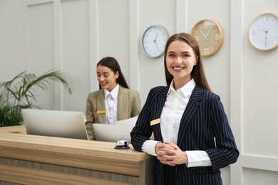 Photo of Portrait of beautiful receptionist near counter in hotel