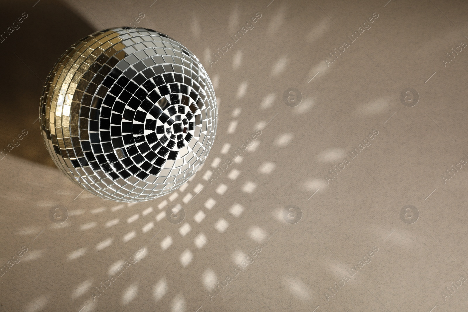 Photo of Shiny disco balls on light grey background, top view. Space for text