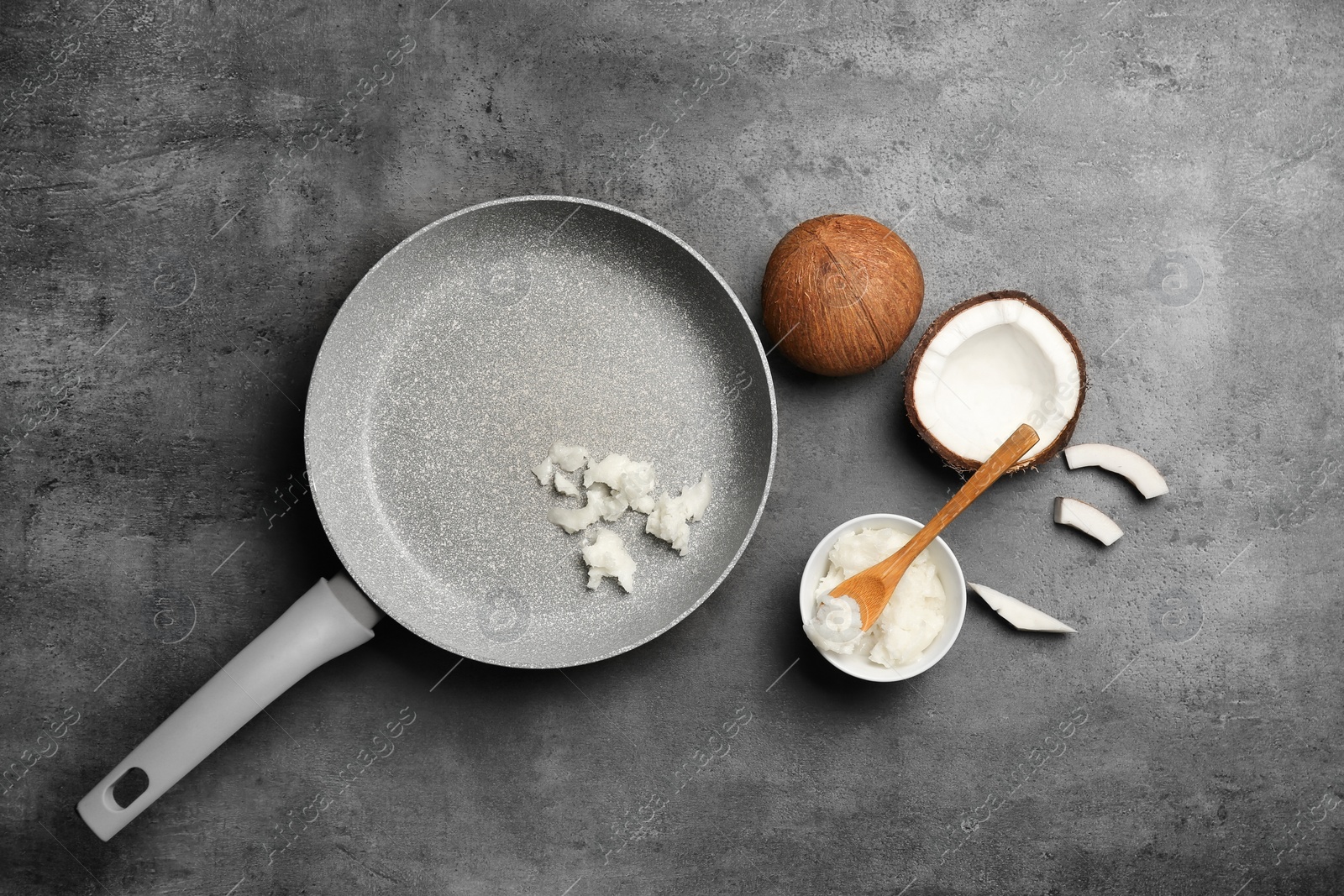 Photo of Flat lay composition with coconut oil and nut pieces on grey background