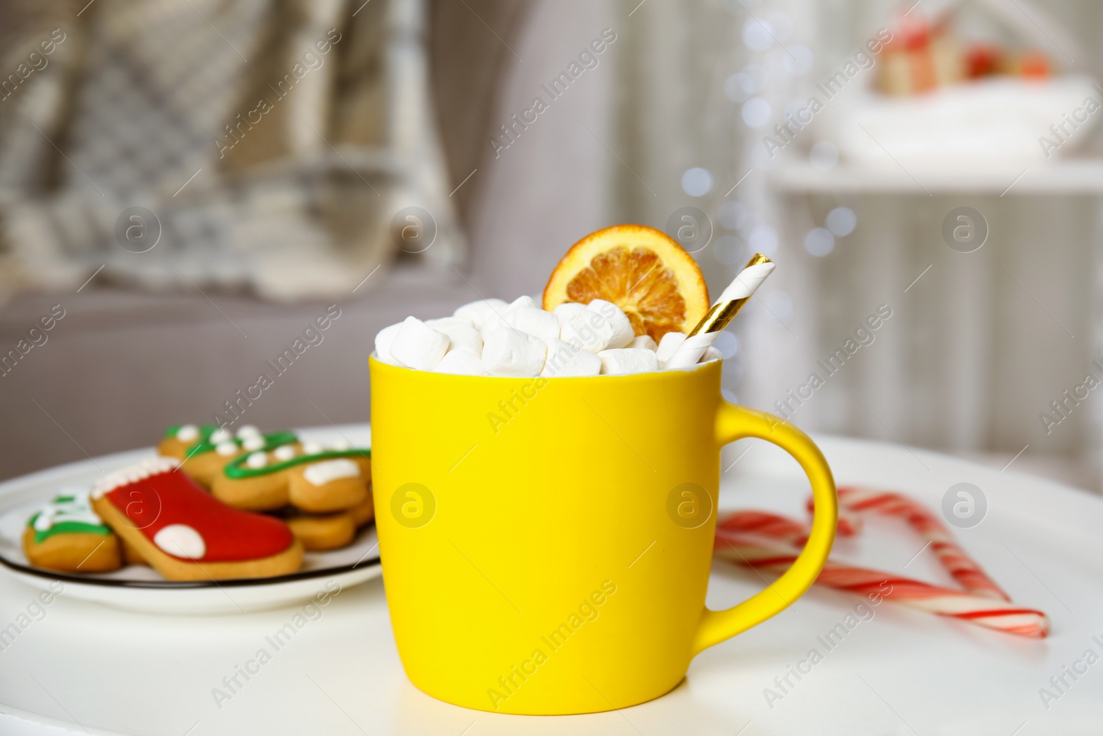 Photo of Cup of hot cocoa with marshmallows on white table indoors. Winter drink