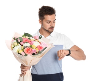 Young handsome man with beautiful flower bouquet on white background