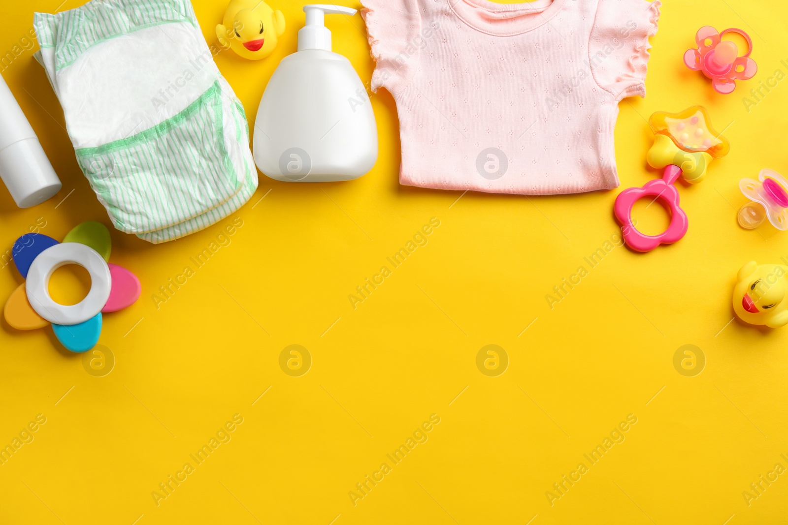 Photo of Flat lay composition with baby accessories and space for text on color background