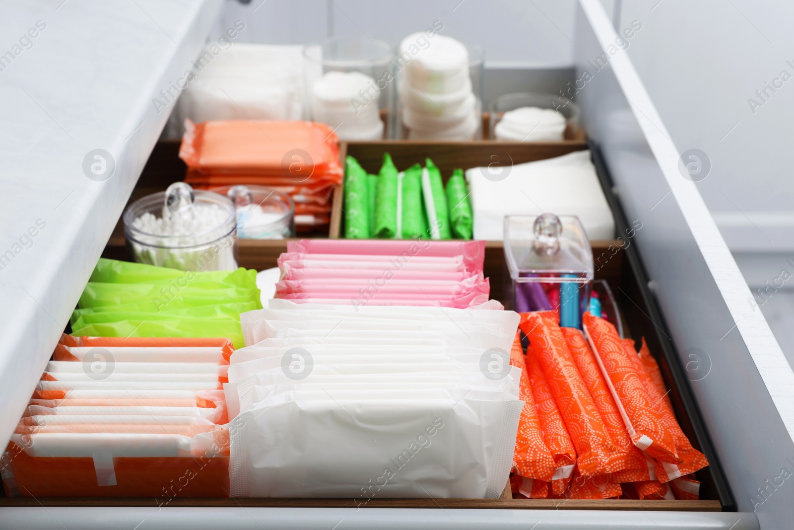 Photo of Storage of different feminine hygiene products in drawer indoors, closeup