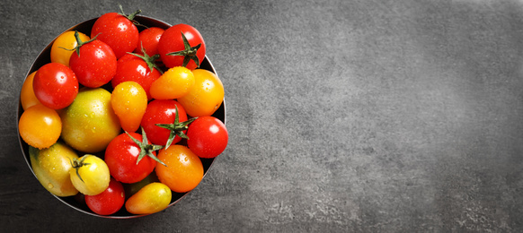 Image of Top view of bowl with fresh tomatoes on grey table, space for text. Banner design 