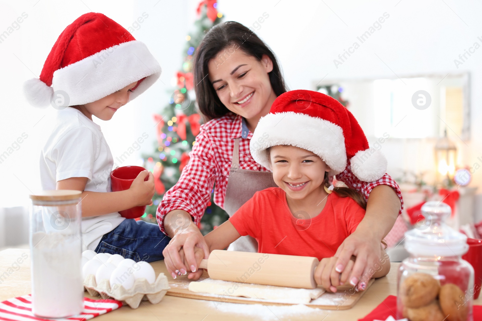 Photo of Mother and children making Christmas cookies together at home