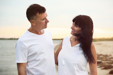 Happy mature couple spending time together on sea beach