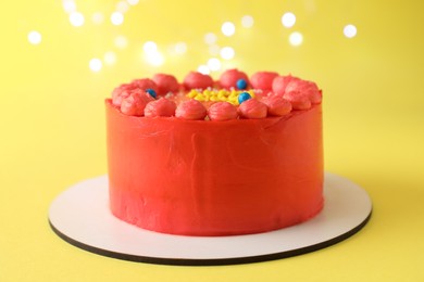 Photo of Cute bento cake with tasty cream on yellow background