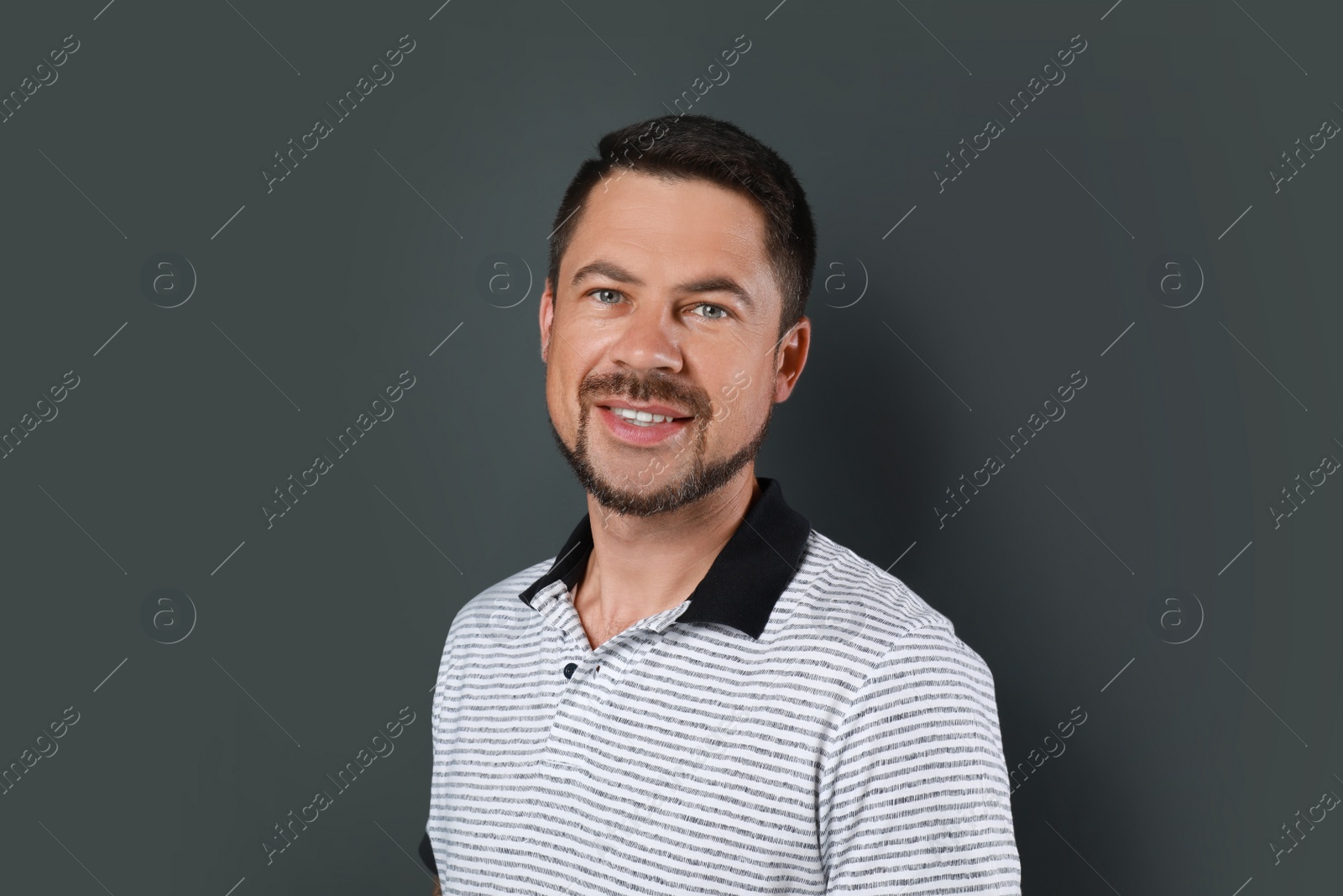 Photo of Portrait of handsome man on dark background