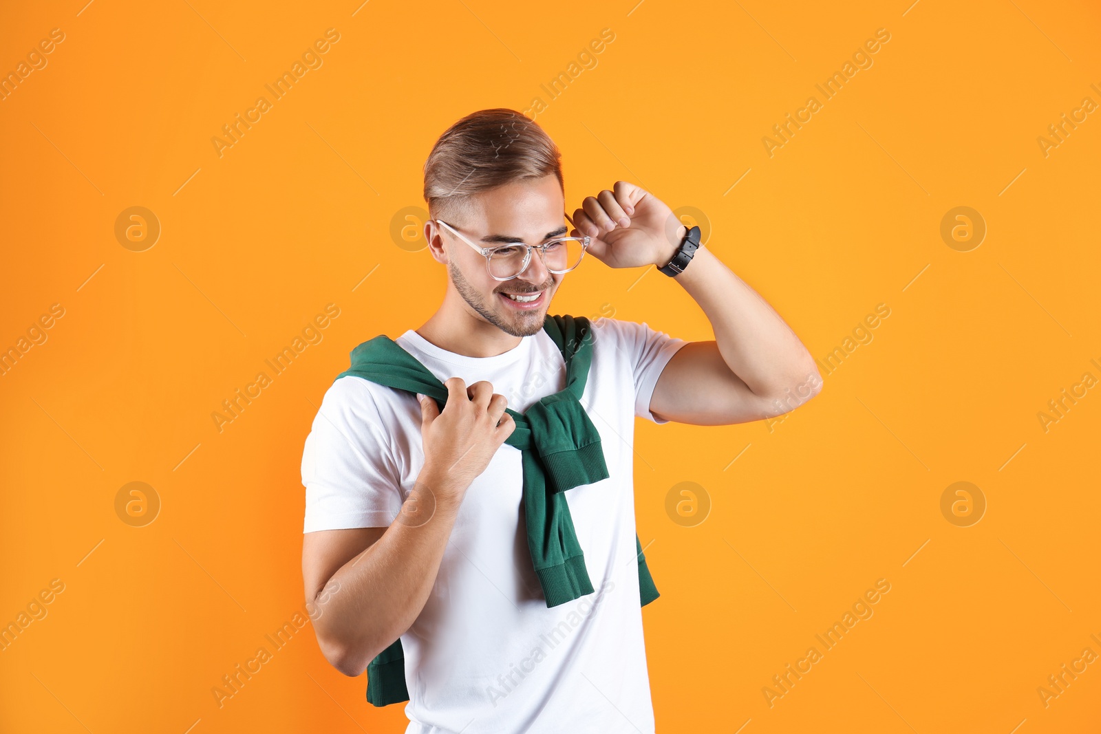 Photo of Young man with trendy hairstyle on color background