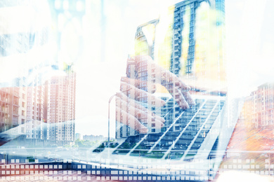 Image of Woman with laptop and modern buildings, closeup. Double exposure