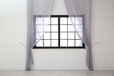 Photo of Modern window with curtains in room. Home interior