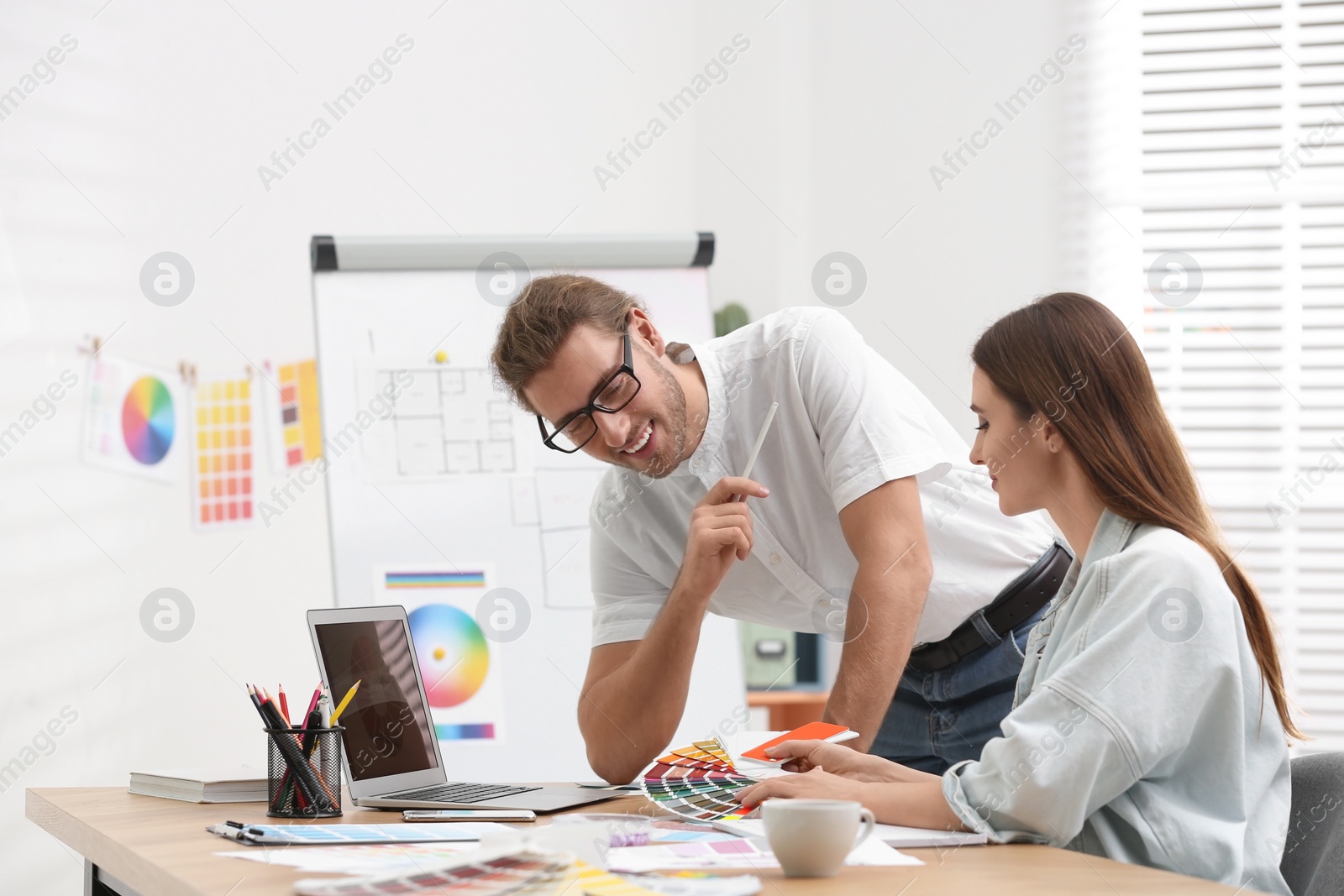 Photo of Professional interior designer with colleague working in office