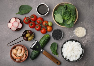 Ingredients for poke bowl on grey table, flat lay