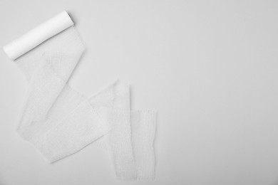 Photo of Medical bandage on white background, top view. Space for text