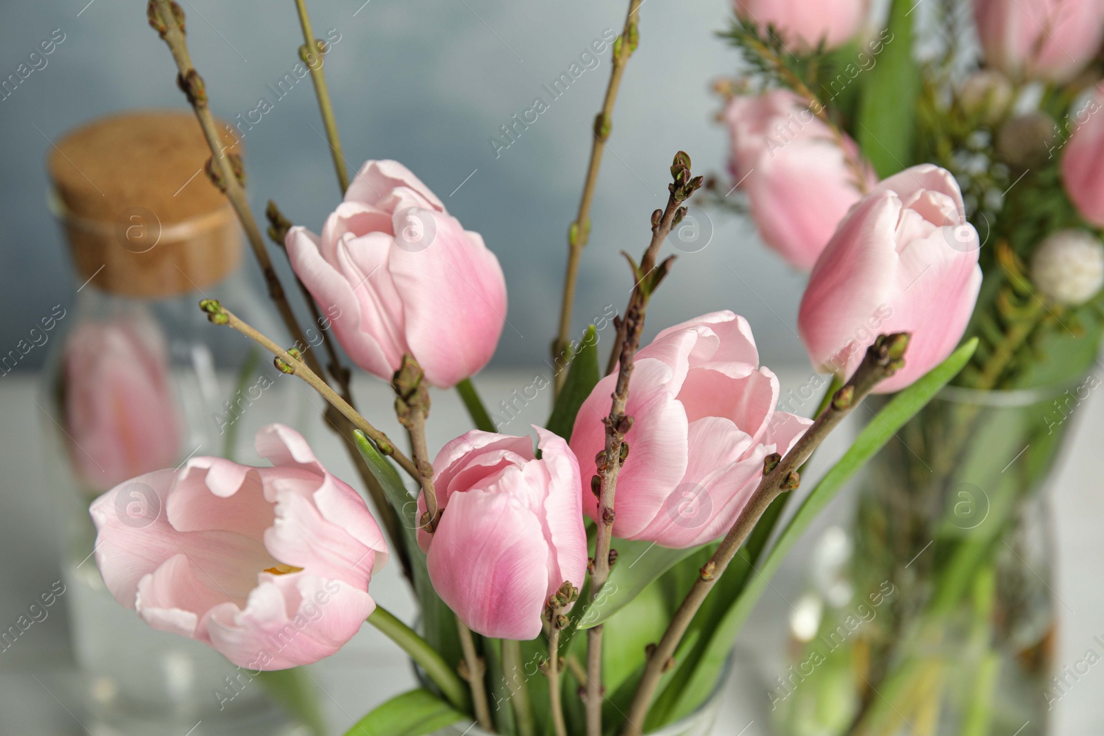 Photo of Beautiful bouquet with spring pink tulips on table, closeup