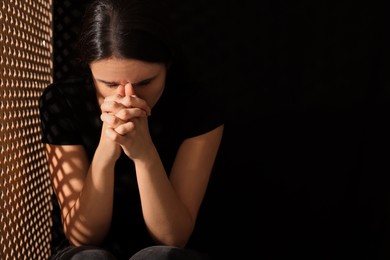 Photo of Upset woman listening to priest during confession near in booth, space for text