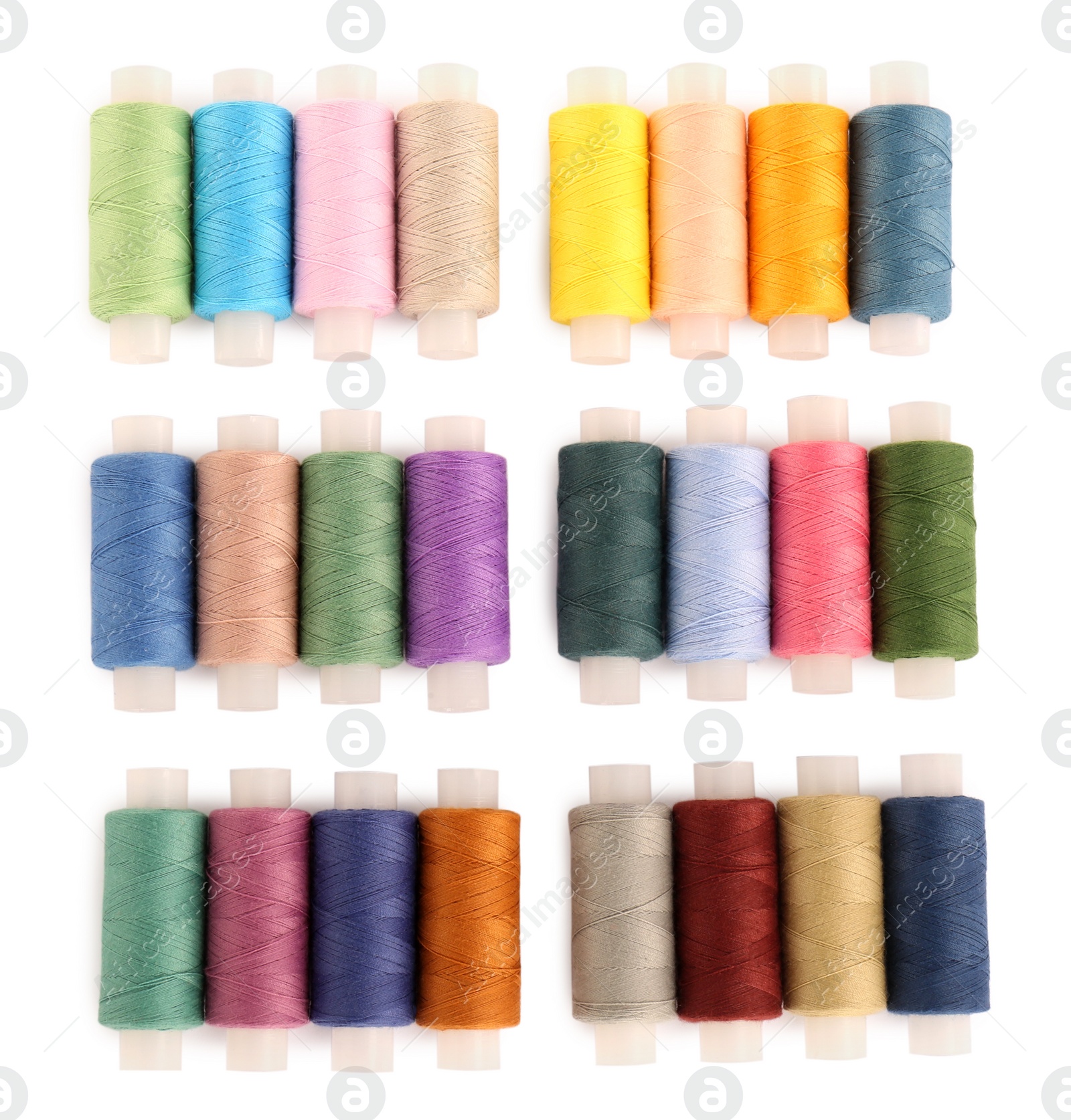 Photo of Set of colorful sewing threads on white background, top view