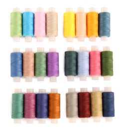 Set of colorful sewing threads on white background, top view