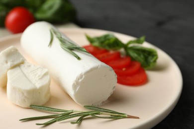 Photo of Delicious goat cheese with rosemary on plate, closeup