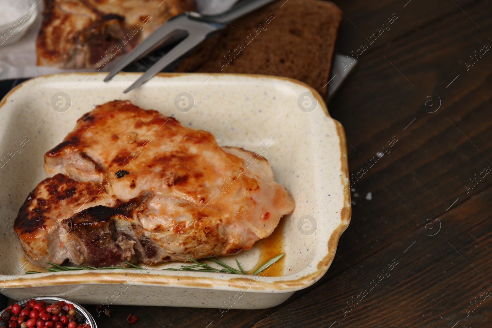 Photo of Tasty marinated meat on wooden table, closeup. Space for text