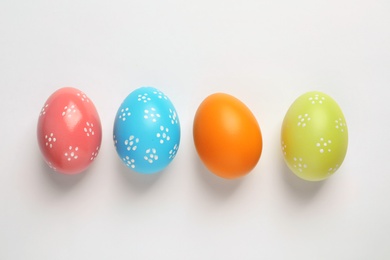 Beautiful painted Easter eggs on white background, top view