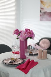 Photo of Beautiful table setting with pink peonies and candles