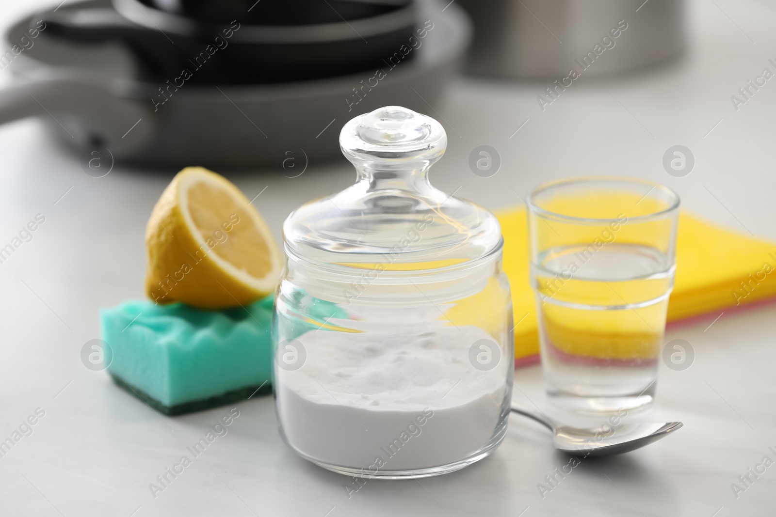 Photo of Baking soda, lemon and vinegar on light stone table. Eco friendly detergents