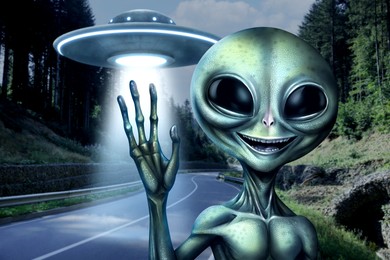 Image of Flying saucer behind alien emitting light outdoors. UFO