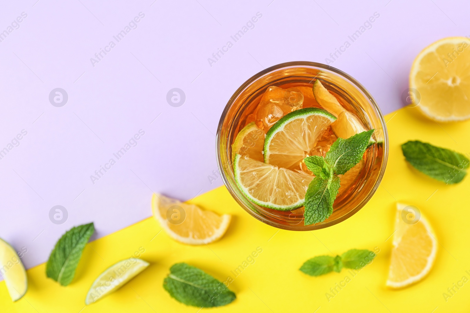 Photo of Flat lay composition with refreshing iced tea on color background