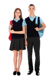 Photo of Full length portrait of teenagers in school uniform with backpacks on white background