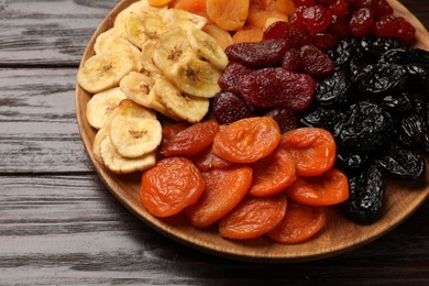 Photo of Delicious dried fruits on wooden table, closeup