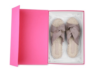 Photo of Pair of stylish shoes in pink box on white background, top view