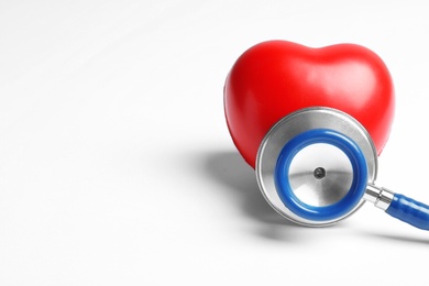 Photo of Stethoscope and heart model on light background, closeup. Medical equipment