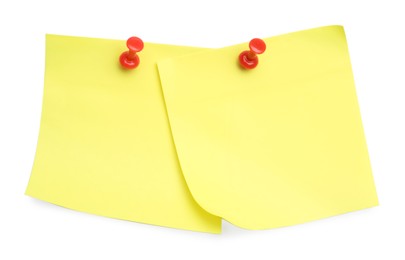 Photo of Blank yellow notes pinned on white background, top view