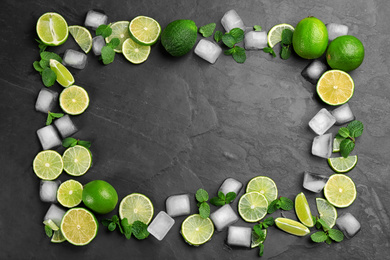 Photo of Frame made of lime slices, mint and ice on black table, top view with space for text. Lemonade layout