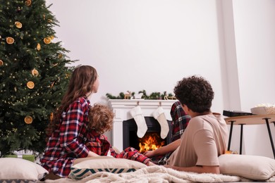 Photo of Family watching movie via video projector at home, back view