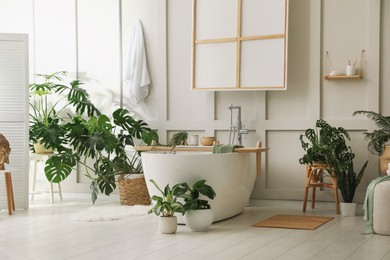 Photo of Stylish bathroom interior with green plants. Home design