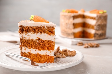 Photo of Sweet carrot cake with delicious cream on white marble table