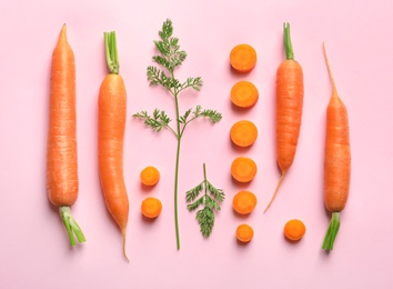 Photo of Flat lay composition with fresh carrots on color background