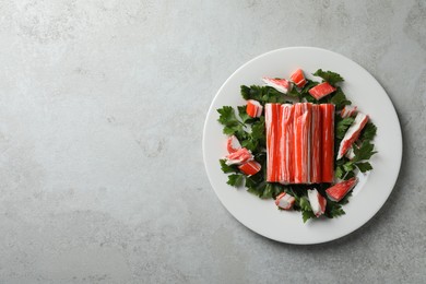 Photo of Crab sticks and parsley on light table, top view. Space for text