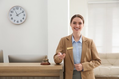 Photo of Portrait of beautiful receptionist near counter in hotel