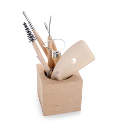 Photo of Set of different clay crafting tools in holder isolated on white