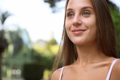 Photo of Portrait of beautiful young woman outdoors, closeup. Space for text