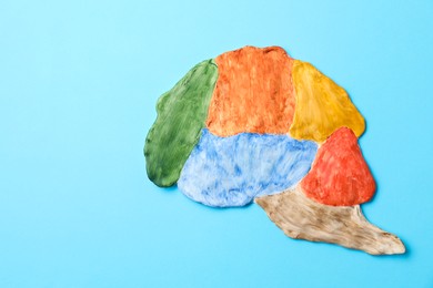 Photo of Amnesia problem. Brain with sections on light blue background, top view. Space for text